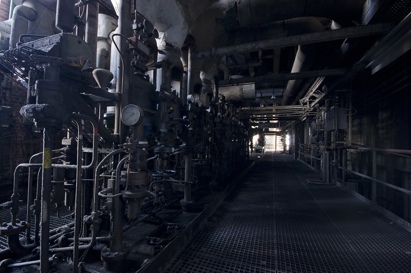 A dark area filled to the brim with pipe work.